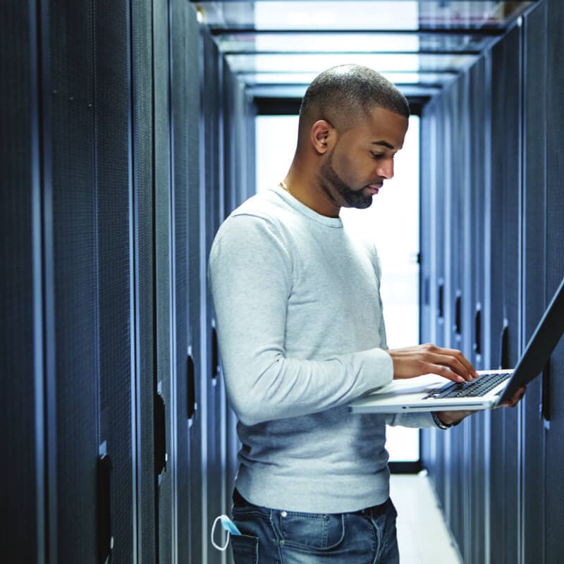 Cybersecurity analyst at illuminated workstation