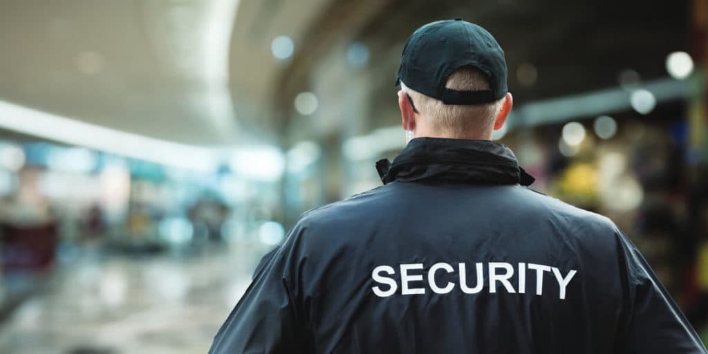Close protection agent in suit and earpiece