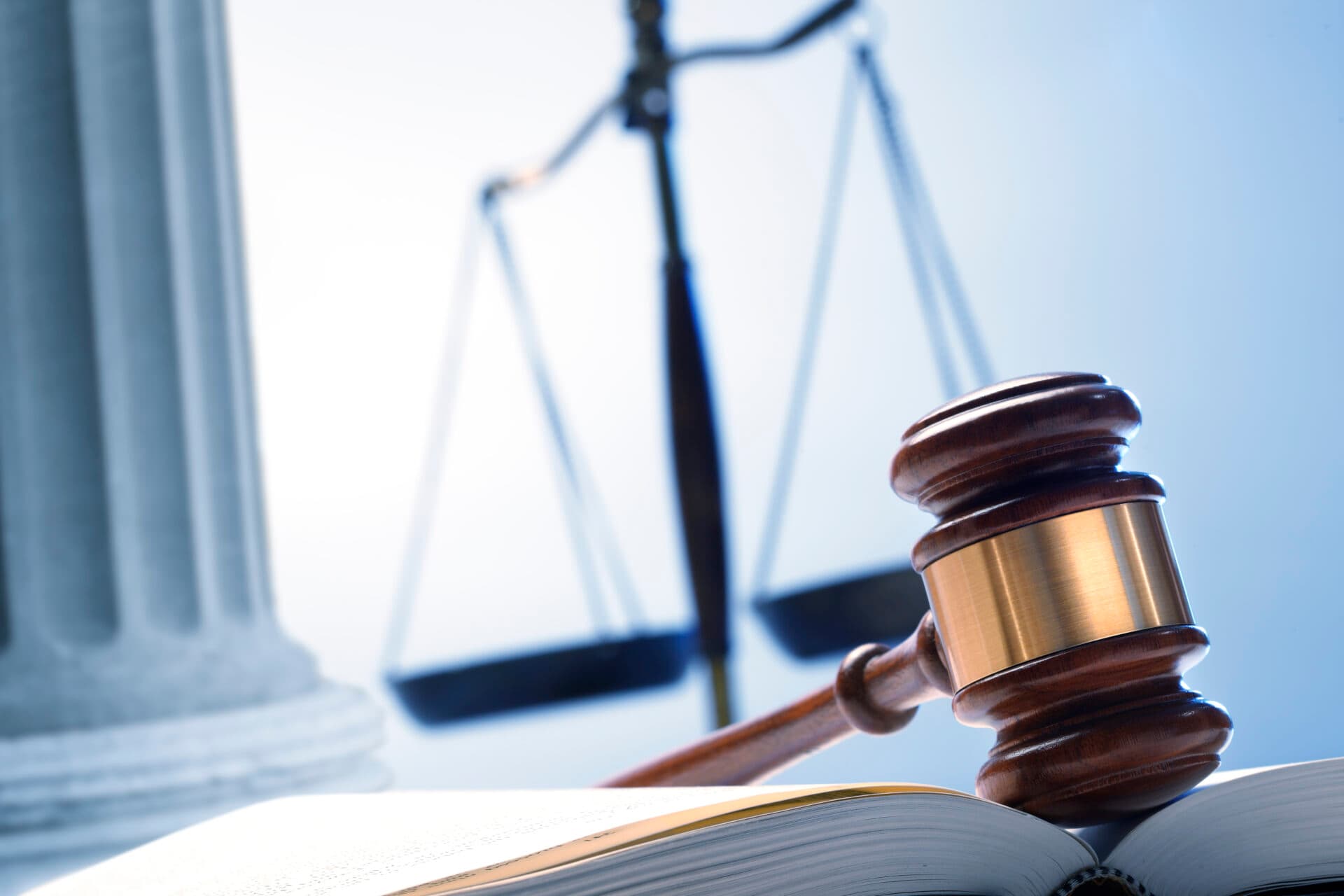 Scales of justice and a gavel resting on a contract